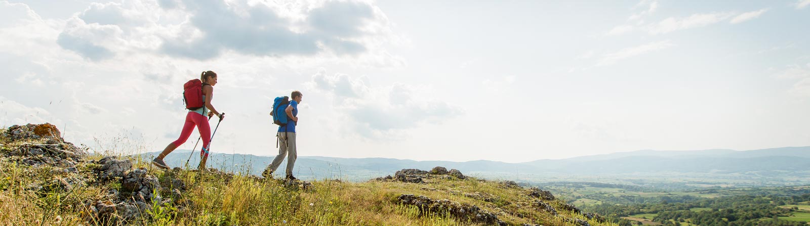 A man and woman couple hiking.
