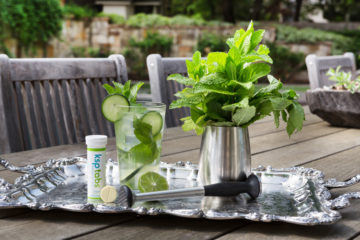 Cucumber mint KSP lime drink on a silver platter.