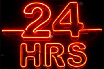 A neon sign displaying 24 hours