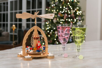 Christmas candle object next to two glasses and KSP tablets. One berry and one Lime.